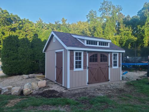 LISB-Medford-12x14-garden-transom-carriage-doors-z-shutters.-Taupe-with-chestnut-doors-and-shutters-brownwood-roof-3