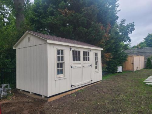 Manhasset-8x14-a-frame-navajo-white-brownwood-6-lite-carriage-house-doors-pvc-matching-corners